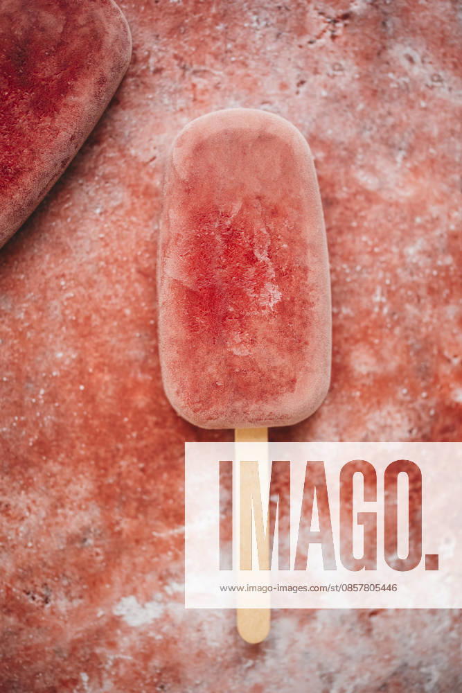 Raspberry popsicle on a red background Raspberry popsicle on a red background