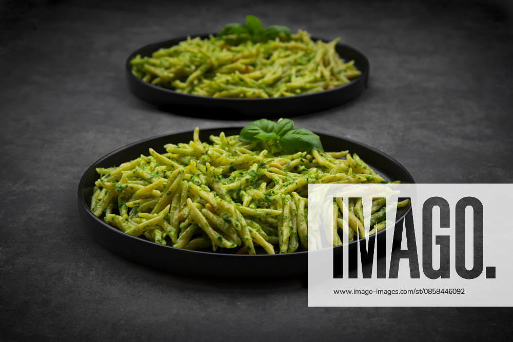 Trofie pasta with genovese pesto and basil on black plates, LVF09719