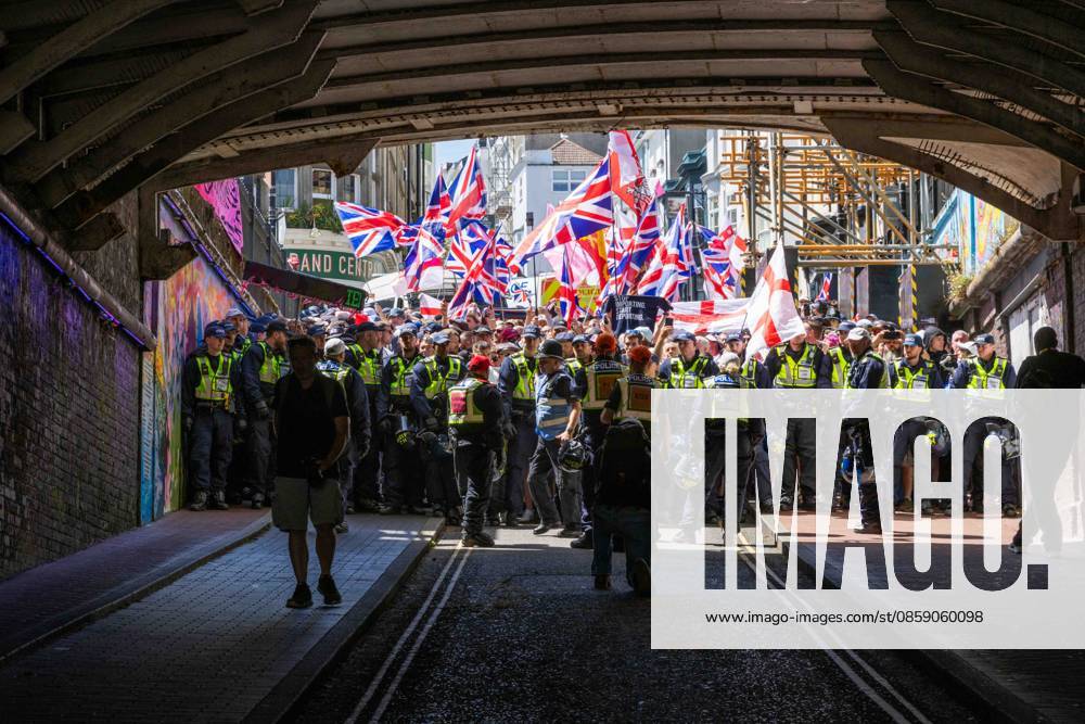 Brighton, UK. 13 June 2026. Members and supporters of anti-immigration group South East Patriots hold a march through the centre of Brighton. A counter-protest, involving about two dozen groups under the banner of Carnival Against Fascism, has also been taking place at the same time, with police officers keeping the two groups apart. South East Patriots claimed the protest is to demand stronger border control, enforcement of immigration laws, and the deportation of illegal immigrants, with the counter protest groups expressing their resistance against the far right as well as to any form of fascism and racism Brighton UK - ZUMAd99_ 20260613_zap_d99_137
