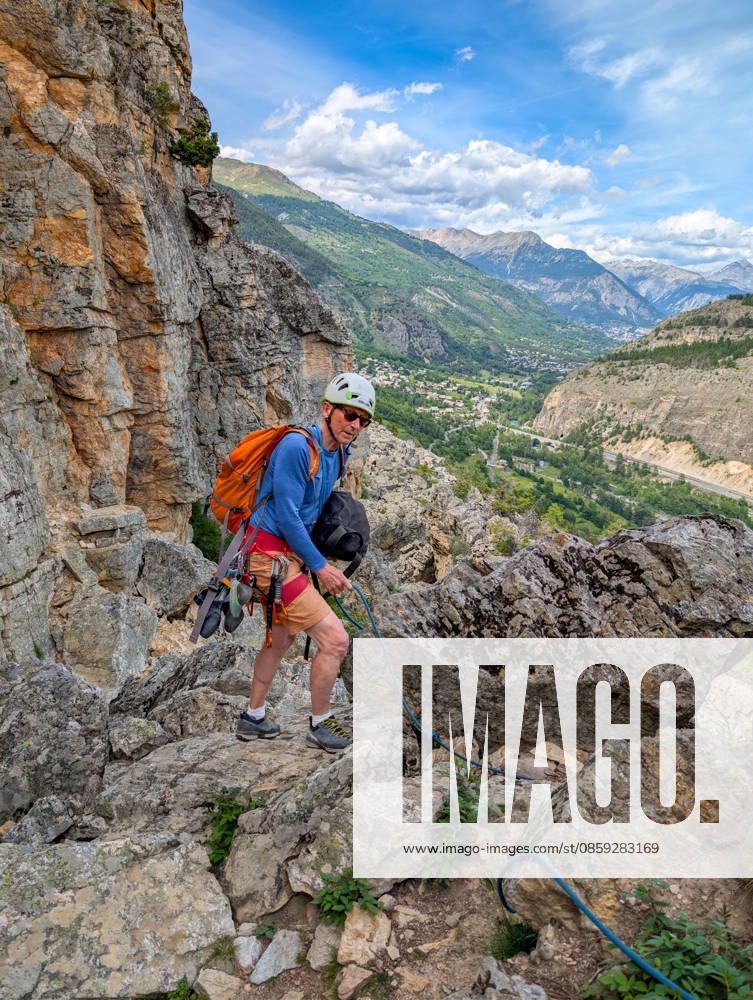 Climbing in Casse de Prelles,detected_source_language in the French Alps a Person with Climbing equipment at a rocky Mountain trail Alps Mountain panorama at a blue Sky 1133302996 ,model released, Symbolfoto
