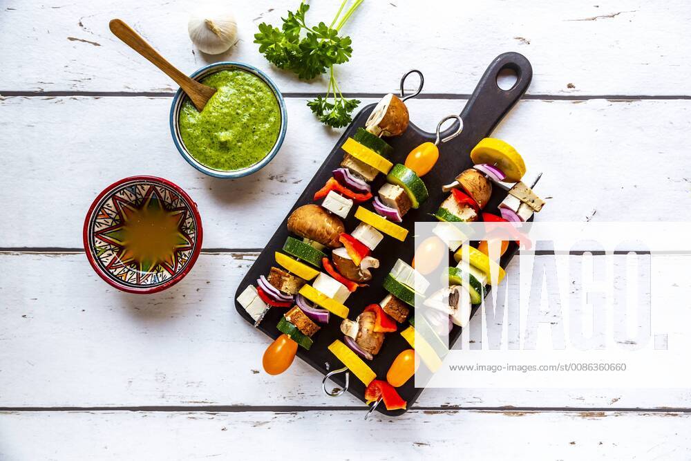 Vegetarian grill skewers, tomato, yellow and green zucchini, tofu, feta, onion and champignon, Argentinian chimichurri SARF03923