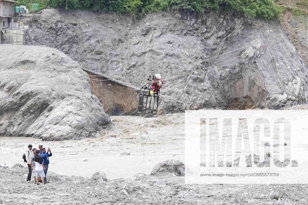 Rescue workers test a pulley rope system inside a basket on September 1, 2026 in Nuwakot, Nepal. Areas of Nepal are still out of the reach of rescue teams, according to the UN, while the death toll from the disaster now exceeds 1,000.