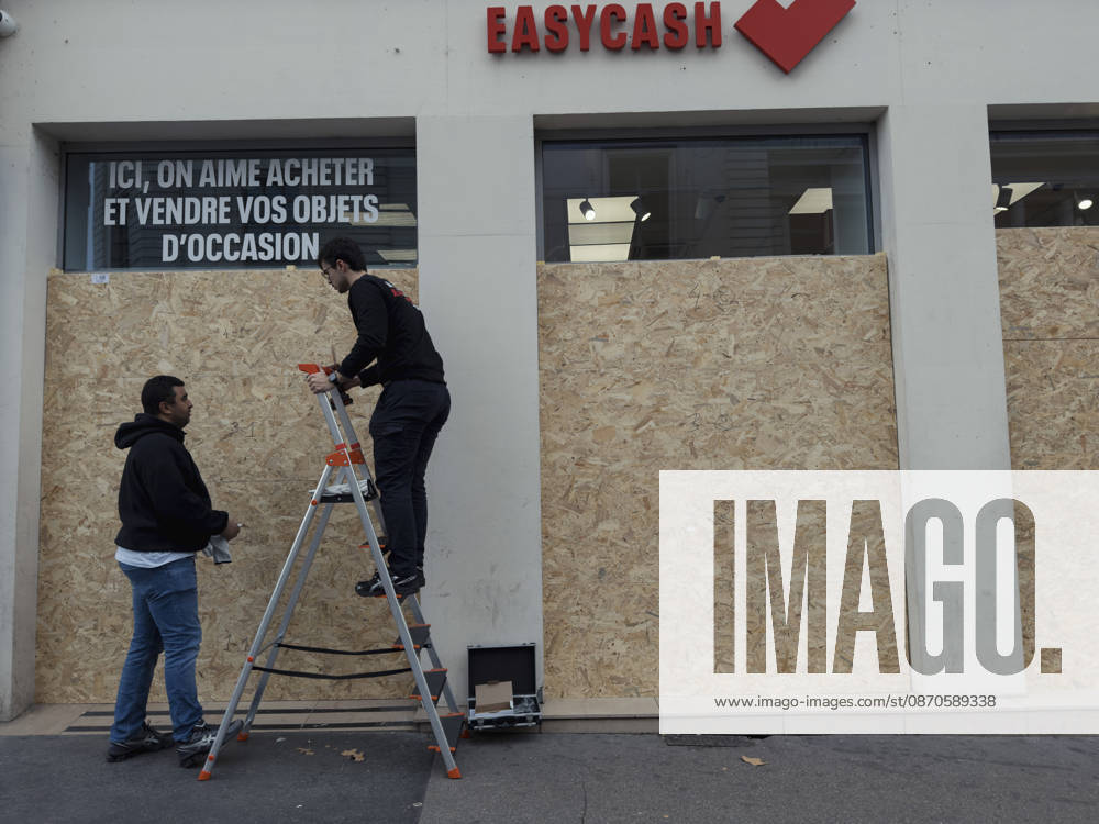 Lyon France Anti-Government Protest Men install wooden panels over the windows of a secondhand goods shop in Lyon, France, on October 24, 2026. Businesses in central Lyon took precautions amid concerns about further unrest following damage to shops during demonstrations the previous weekend. Lyon Rhone Alpes France