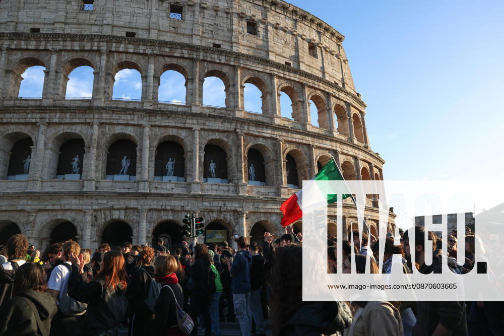 (261024) -- ROME, Oct. 24, 2026 -- Demonstrators march past the Colosseum during an anti-war march in Rome, Italy, Oct. 24, 2026. Protests over rising living costs, military expansion and increased arms spending swept across several Italian cities on Saturday, with clashes between demonstrators and police reported in multiple locations. In Rome, demonstrators set off from Piazza della Repubblica, according to the ANSA news agency. Clashes erupted between protesters and police in the city center later in the evening, prompting police to use water cannons and tear gas in an attempt to disperse the crowds. ) ITALY-ROME-PROTESTS WangxKaiyan