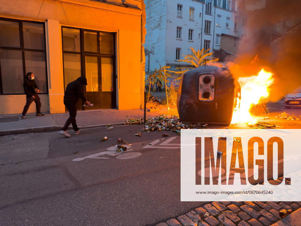 Lyon France Protests October 24 Two demonstrators stand near a fire on a street during a protest in Lyon, France on October 24, 2026. Authorities deployed around 70,000 security personnel across France for renewed protests over the cost of living, after unrest a week earlier saw public buildings damaged, hundreds of shops looted and about 2,700 people arrested. Lyon Rhone Alpes France