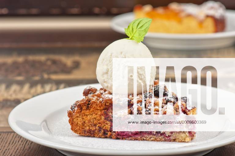 Crumble pie with black currants. English dessert with creamy ice cream