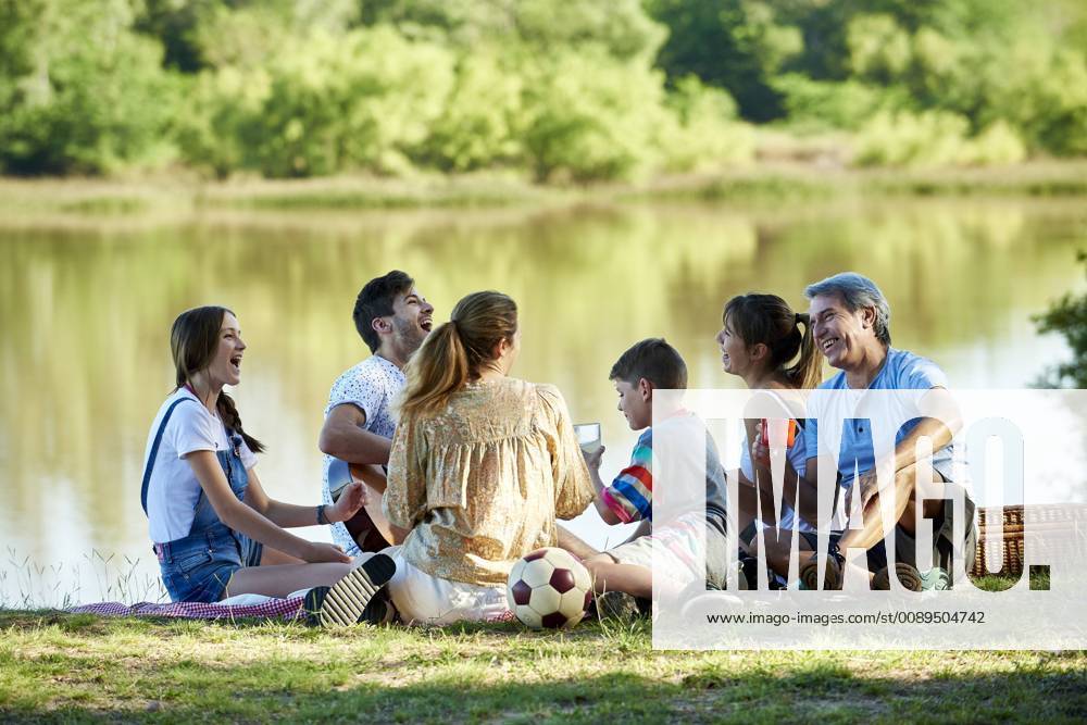 Family enjoying picnic near lake