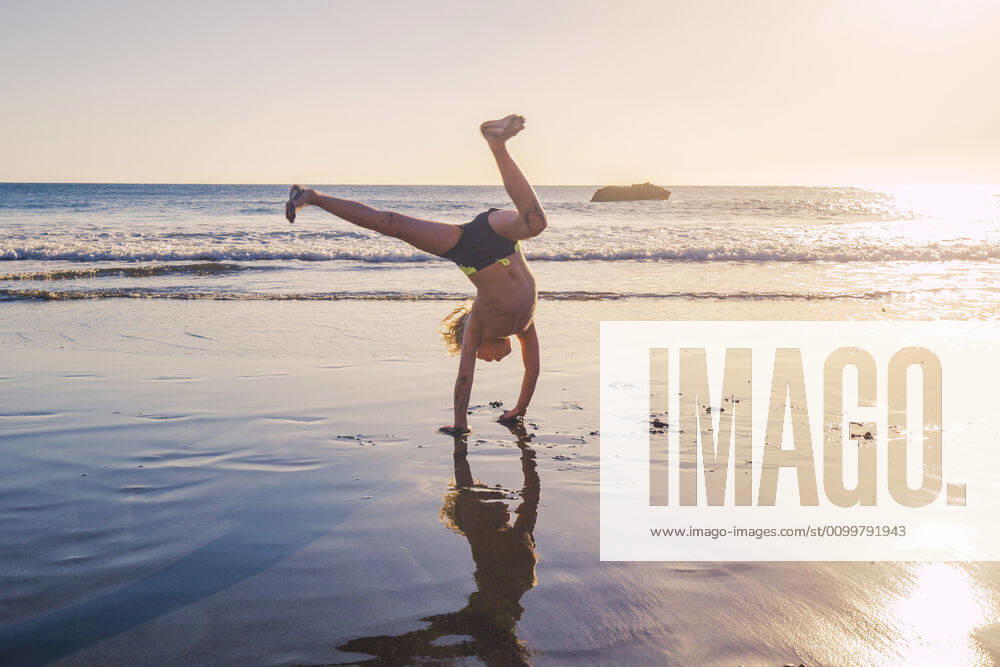 Little boy practicing handstand on the beach model released Symbolfoto IHF00320
