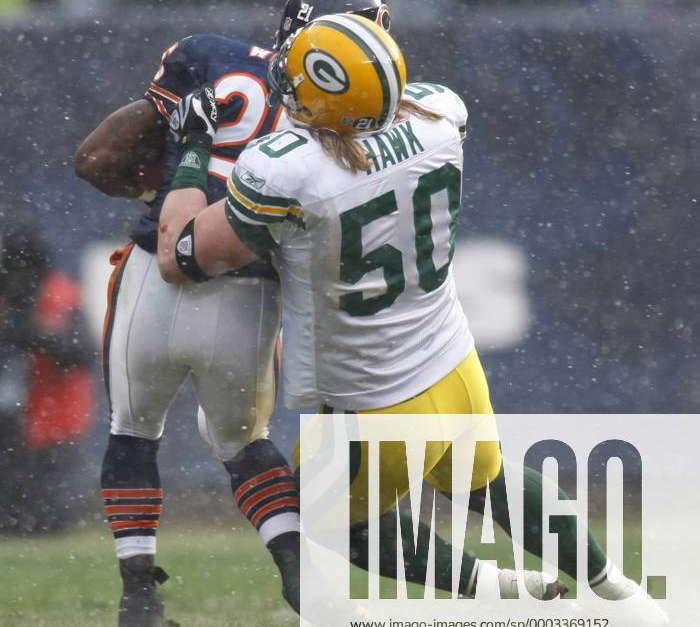 Green Bay Packers linebacker A. J. Hawk (50) stops Chicago Bears running  back Garrett Wolfe (25) for