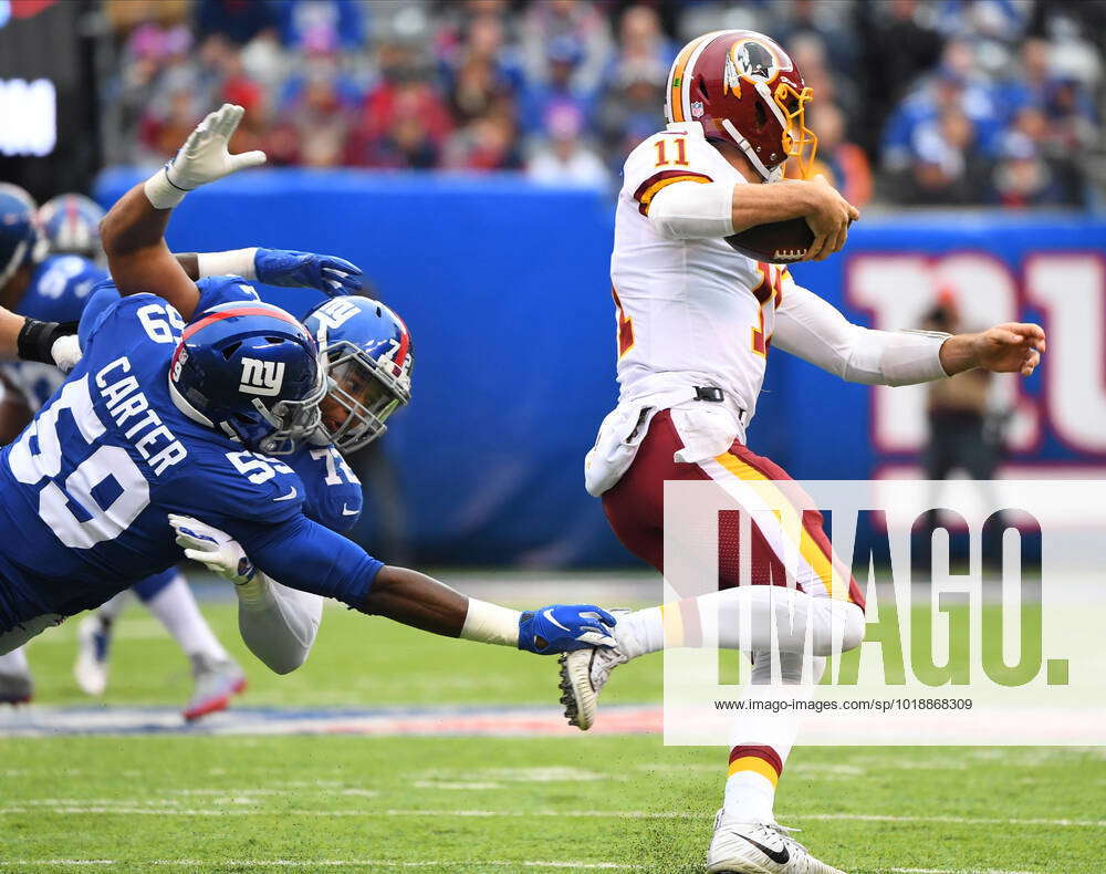 East Rutherford, New Jersey, USA. 28th Oct, 2018. Washington Redskins  quarterback Alex Smith (11) scrambles by New York Giants linebacker Lorenzo  Carter (59) and defensive end Kerry Wynn (72) in the first