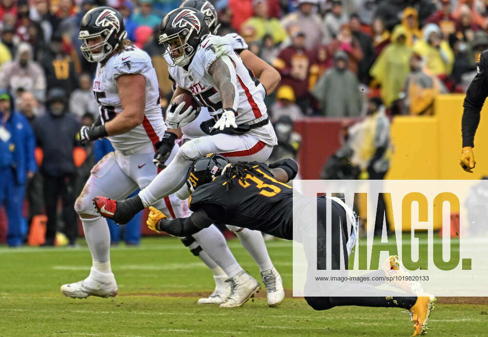 November 27, 2022: Atlanta Falcons running back Tyler Allgeier (25) leaps  over Washington Commanders safety Kamren Curl (31) during the NFL game  between the Atlanta Falcons and the Washington Commanders in Landover