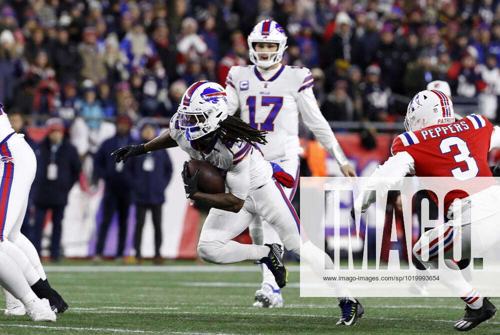 FOXBOROUGH, MA - DECEMBER 01: Buffalo Bills running back James Cook (28)  escapes a tackle during a game between the New England Patriots and the  Buffalo Bills on December 1, 2022, at