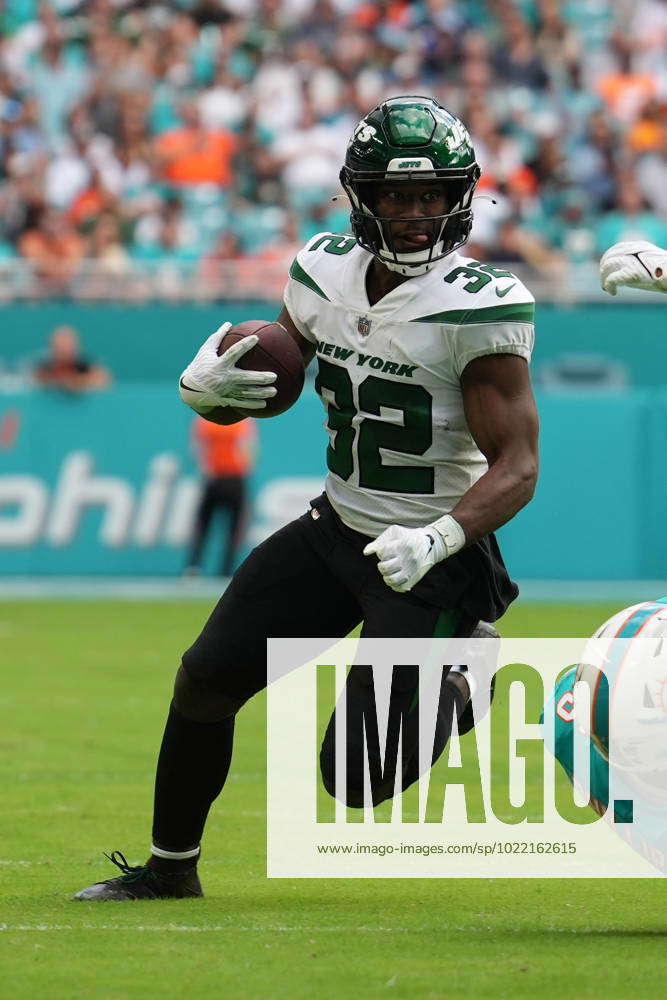 New York Jets running back Michael Carter (32) runs with the ball during an  NFL football game against the Miami Dolphins, Sunday, Jan. 8, 2023, in  Miami Gardens, Fla. (AP Photo/Doug Murray