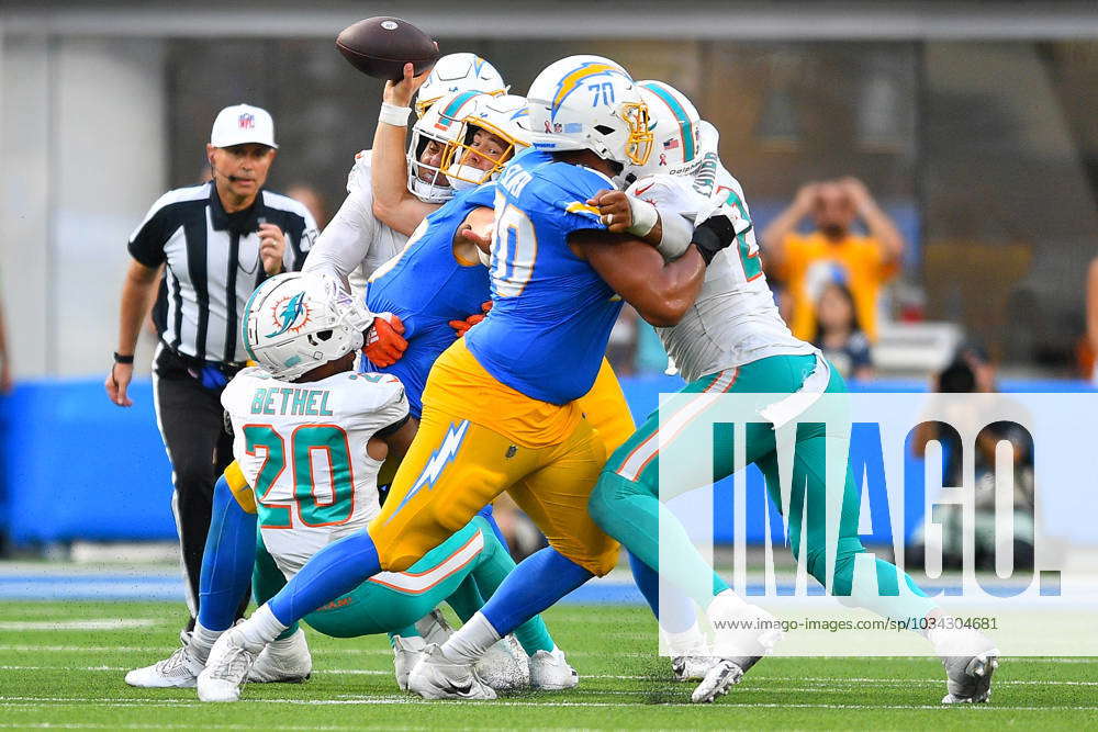 Los Angeles Chargers quarterback Justin Herbert (10) is sacked by Miami  Dolphins cornerback Justin Bethel (20) and linebacker Jaelan Phillips (15)  during an NFL football game, Sunday, Sept. 10, 2023, in Inglewood