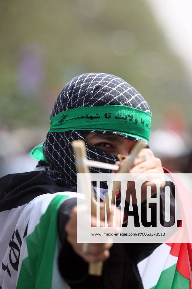 Young man wearing a palestinian keffiyeh scarf