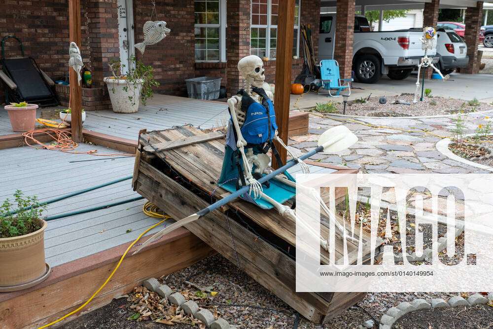 A Halloween skeleton wearing a life preserver and paddling a