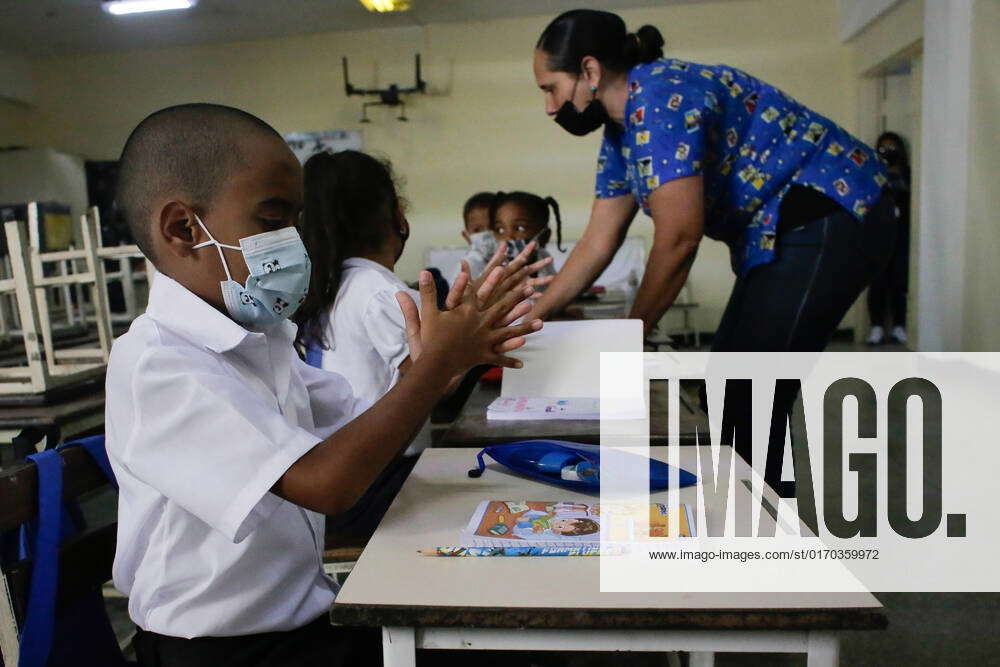 Start Of The School Year In Caracas, Venezuela A boy disinfects his