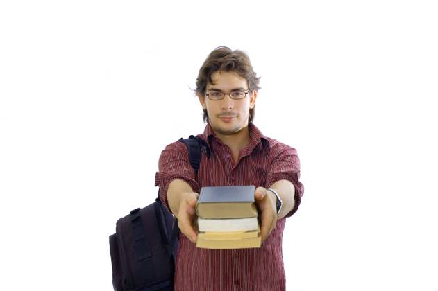 Video: Portrait of male student holding books in school library with ...