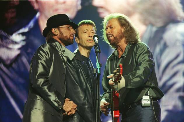THE BEE GEES British Pop Group :- MAURICE GIBB: ROBIN GIBB: BARRY GIBB Seen  in concert at Wembley
