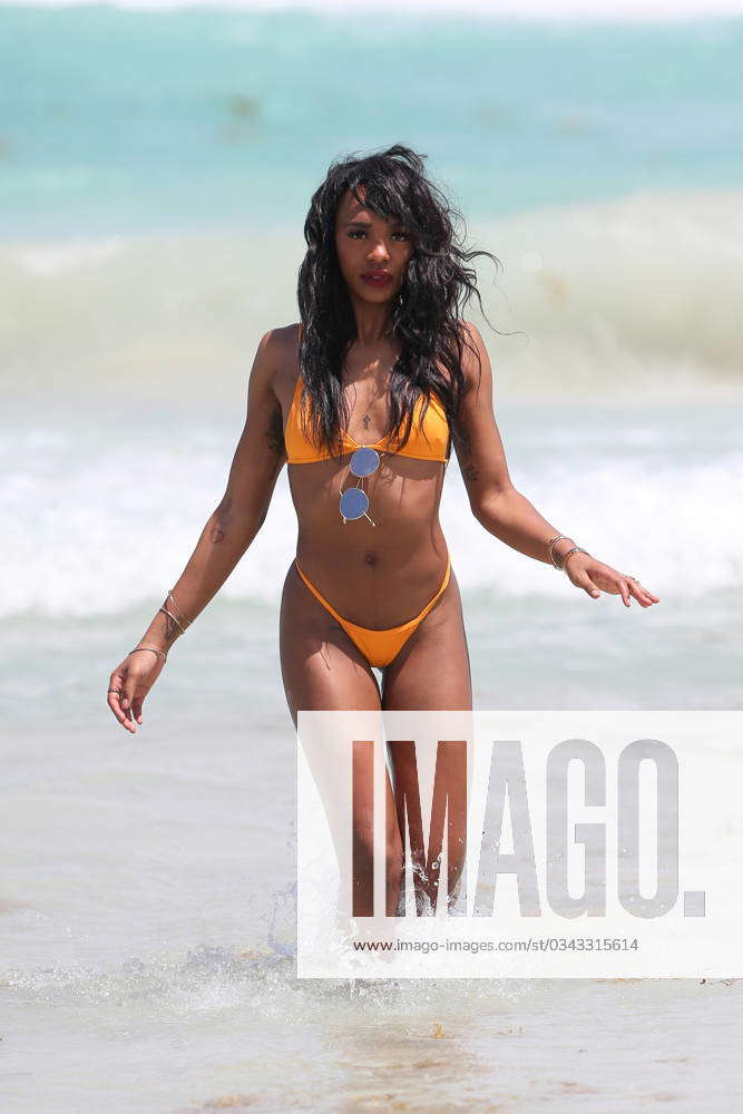 EXCLUSIVE Elisa Johnson rocks a tiny orange bikini as she hits