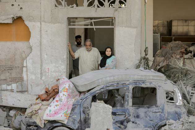 Gaza Ruins After Israili strikes Residents examine the ruins of a ...