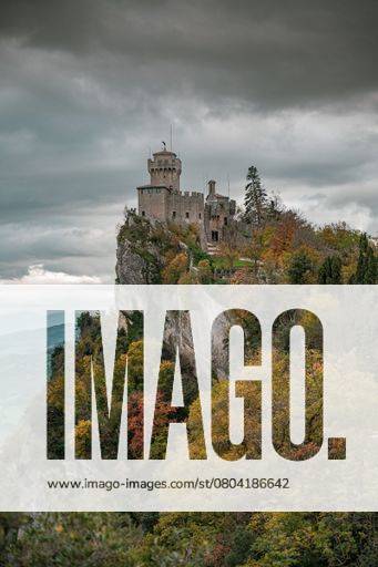 Majestic castle perched on a rocky cliff surrounded by lush autumn ...